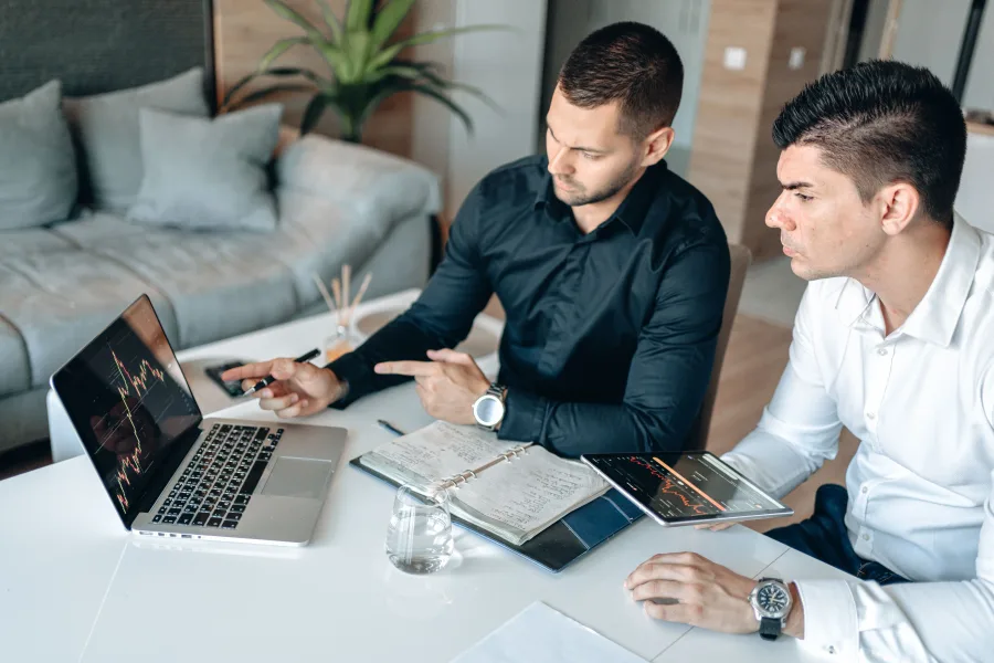 Business professionals evaluating exhibition opportunities and reviewing information